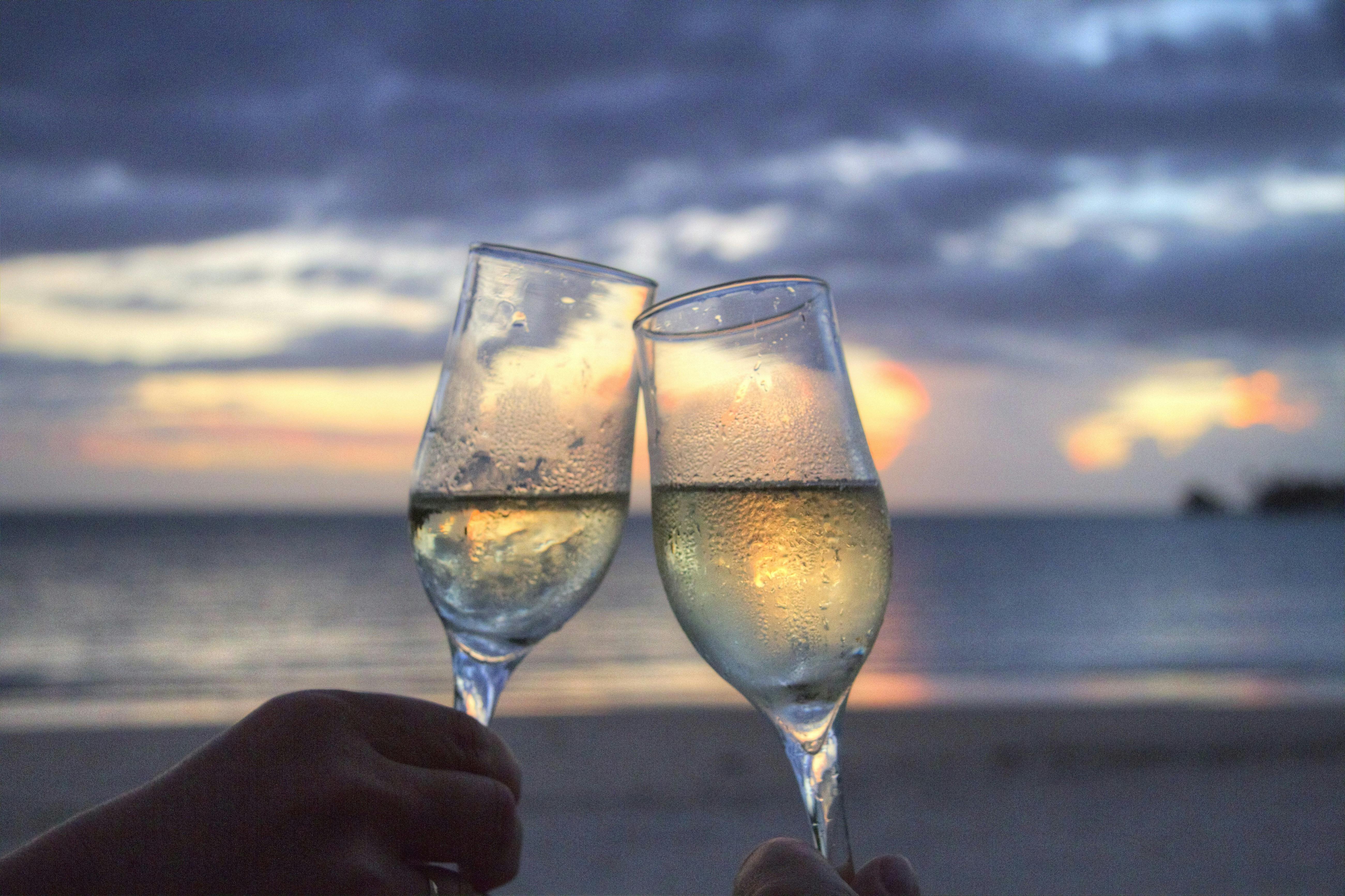 people clinking glasses on the beach