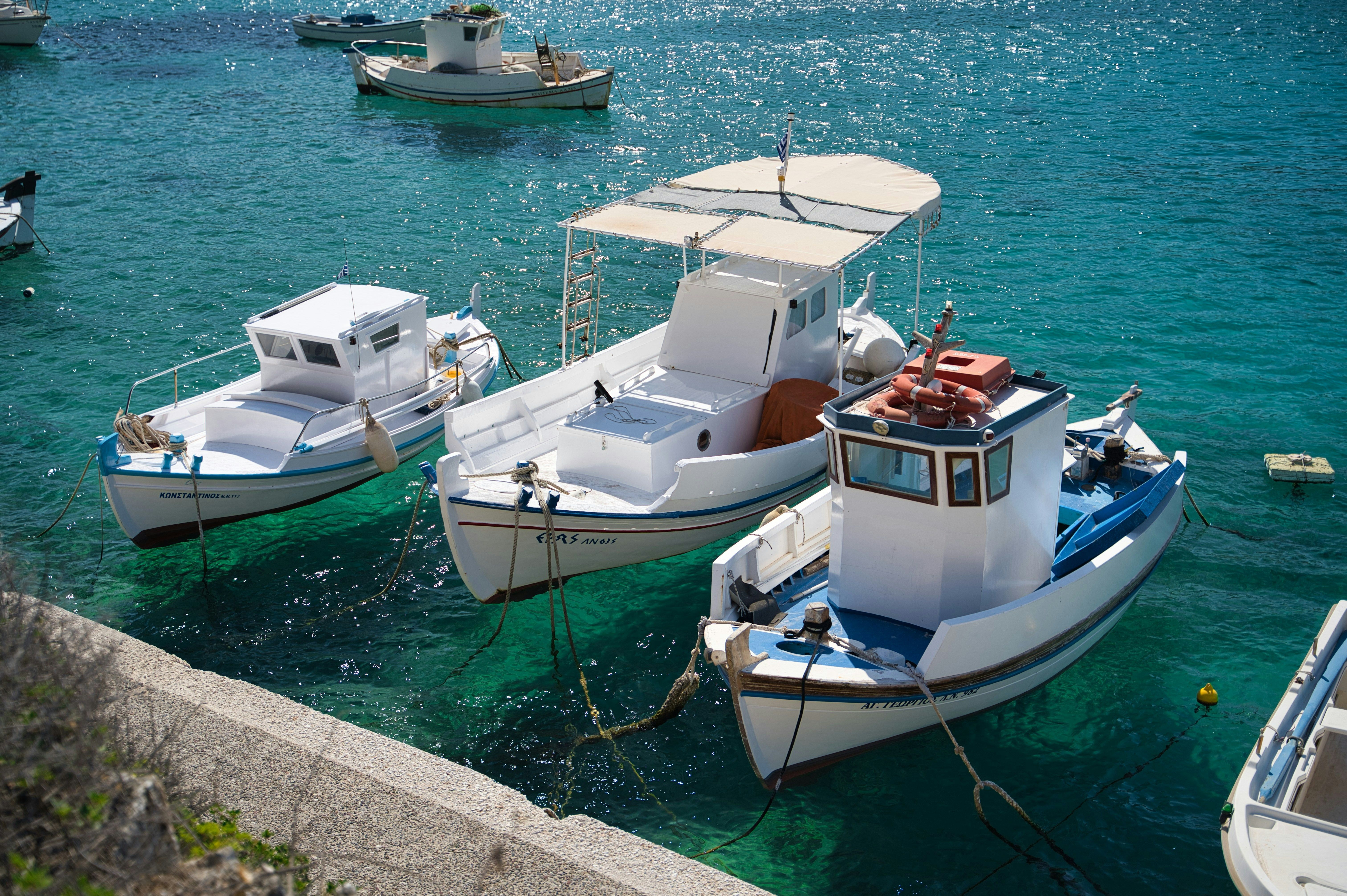 boats docked in the water in Paros
