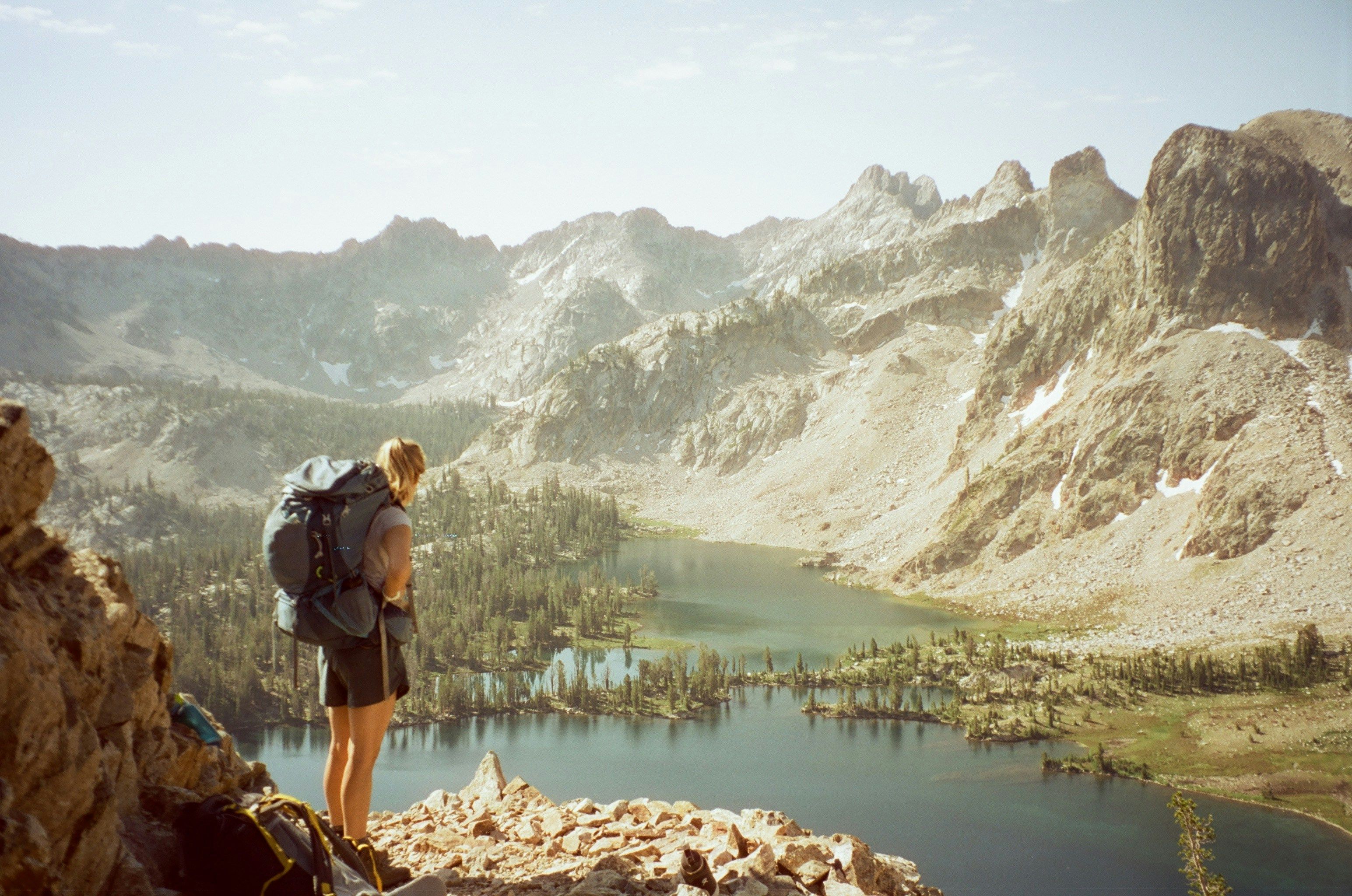 a backpacker in the mountains looking at the scenery