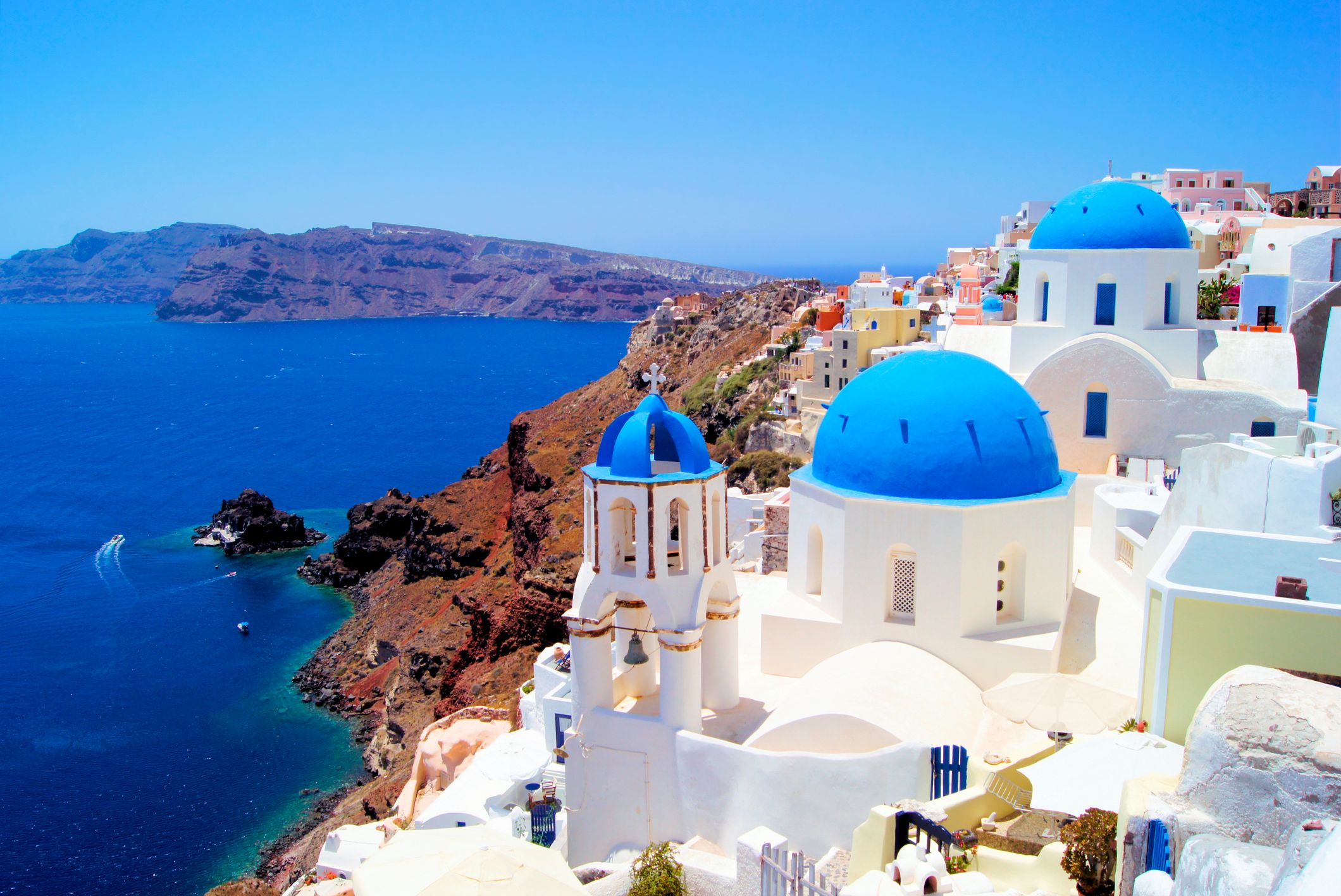 blue and white buildings on the cliffside in Santorini