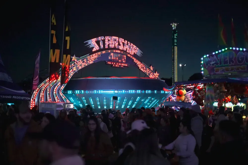 starship attraction lit up at night.webp