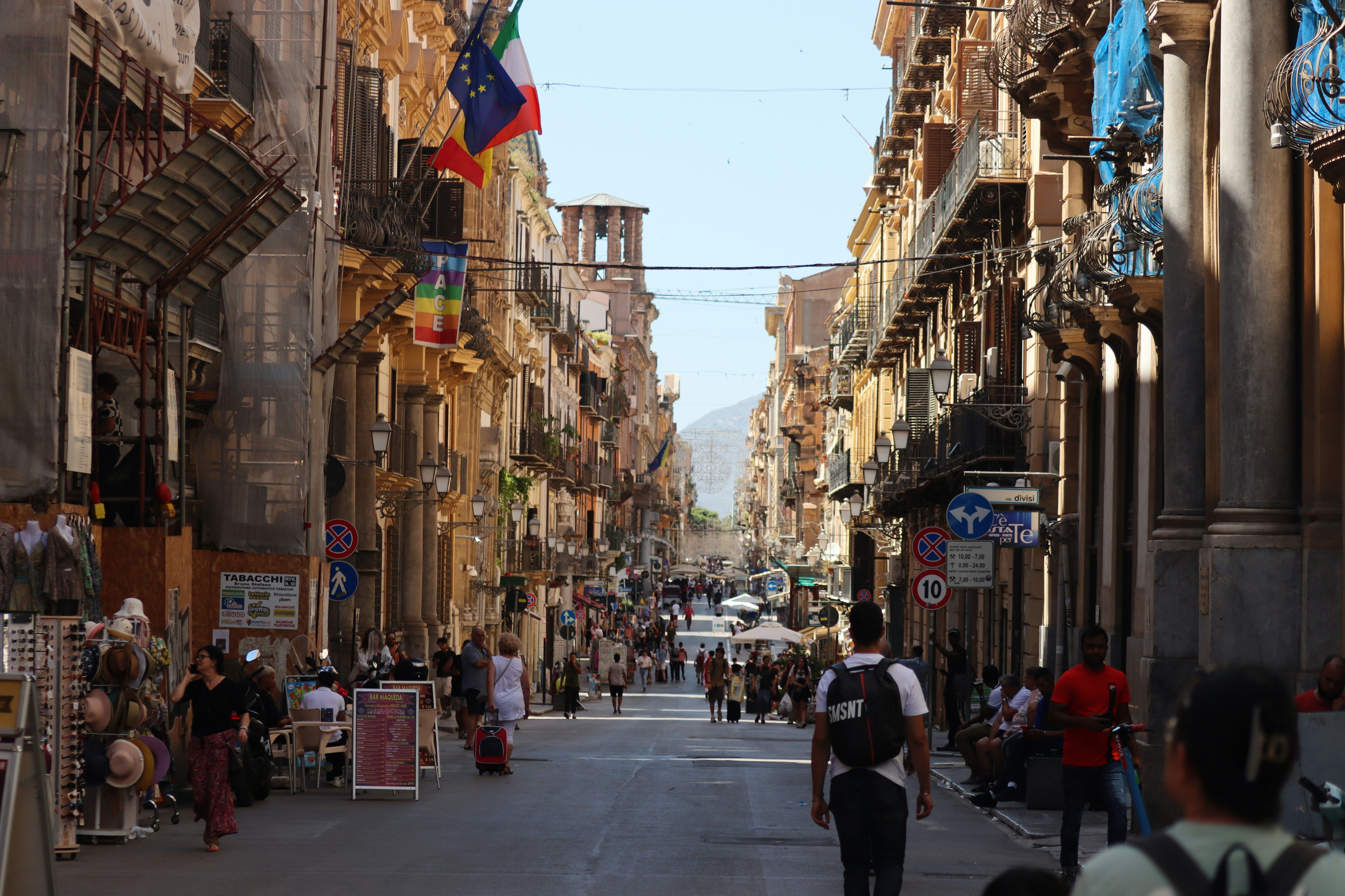people walking down a busy street in Palermo