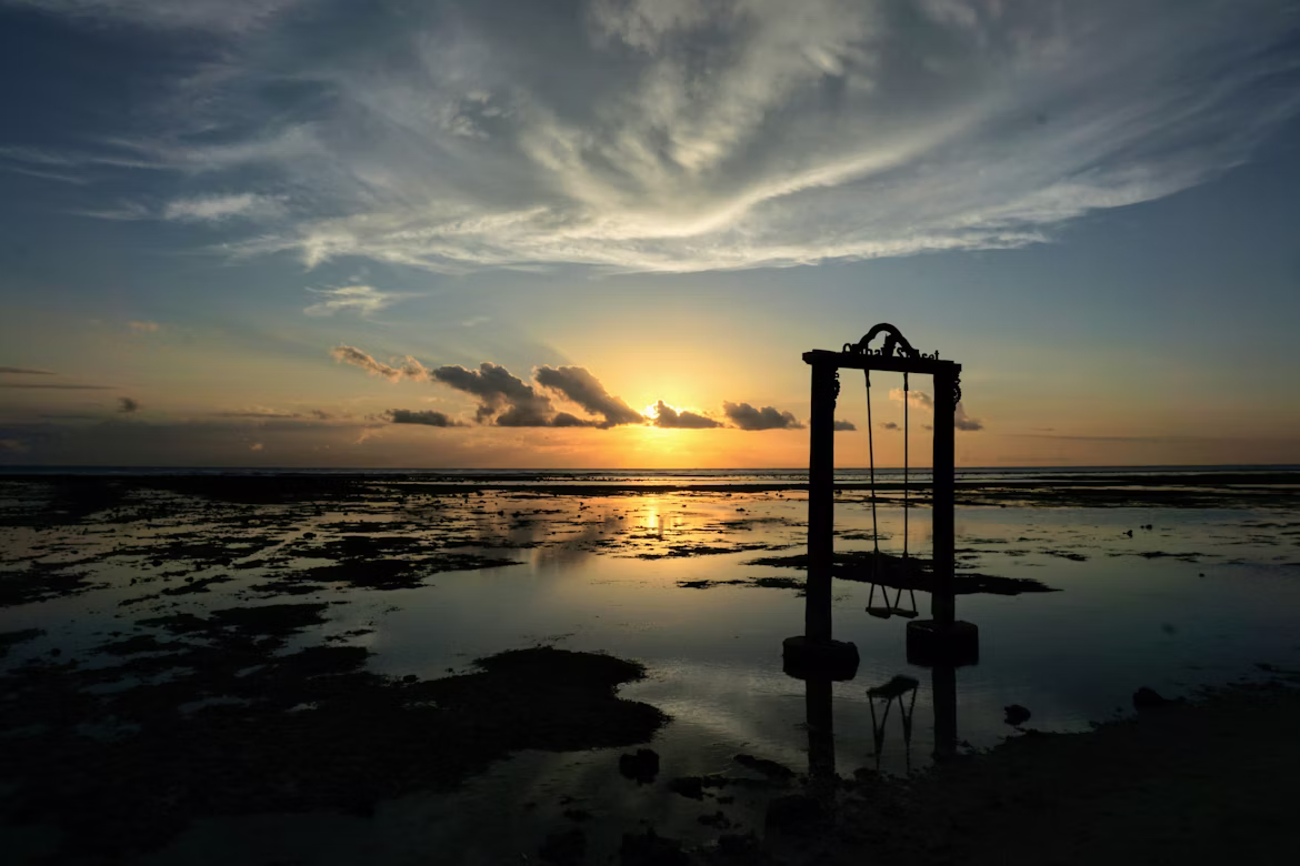 swing in the sea during sunset in Gili Trawangan
