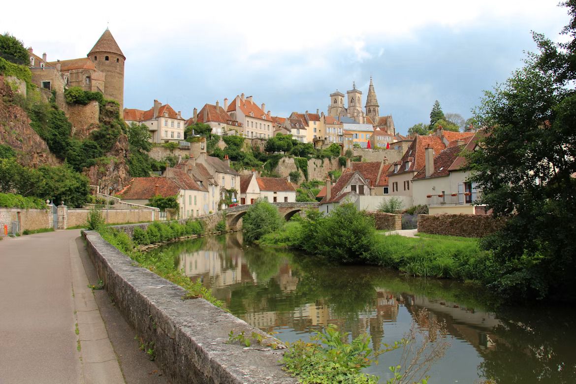the ancient town of Semur-en-Auxois with a calm river running by the houses.jpg