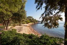 Sandy bay backed by green forests in Bodrum