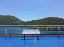 empty ferry deck with green hills behind