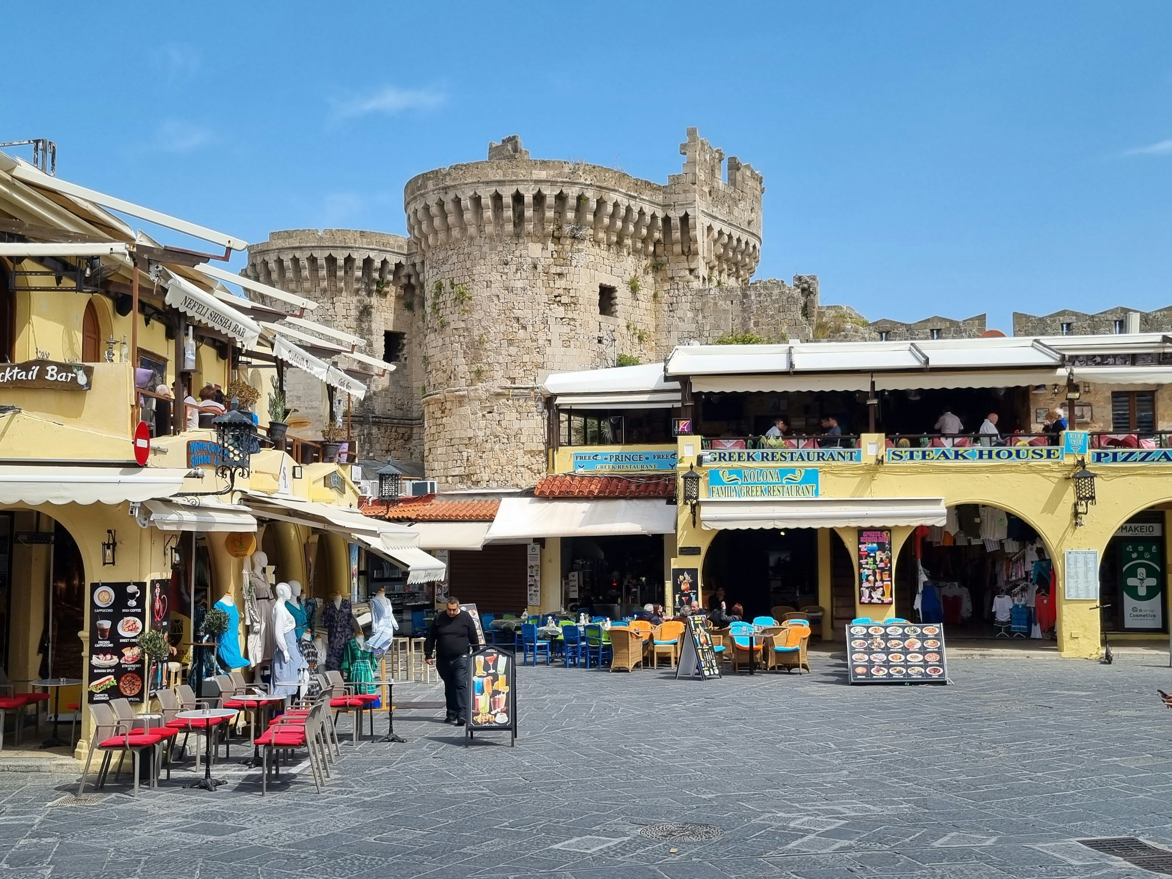 shops and restaurants in front of a historic building