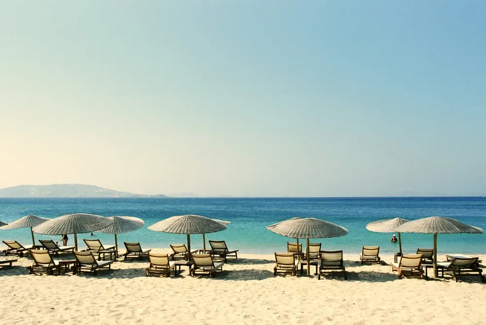 umbrellas along a sandy beach in Santorini