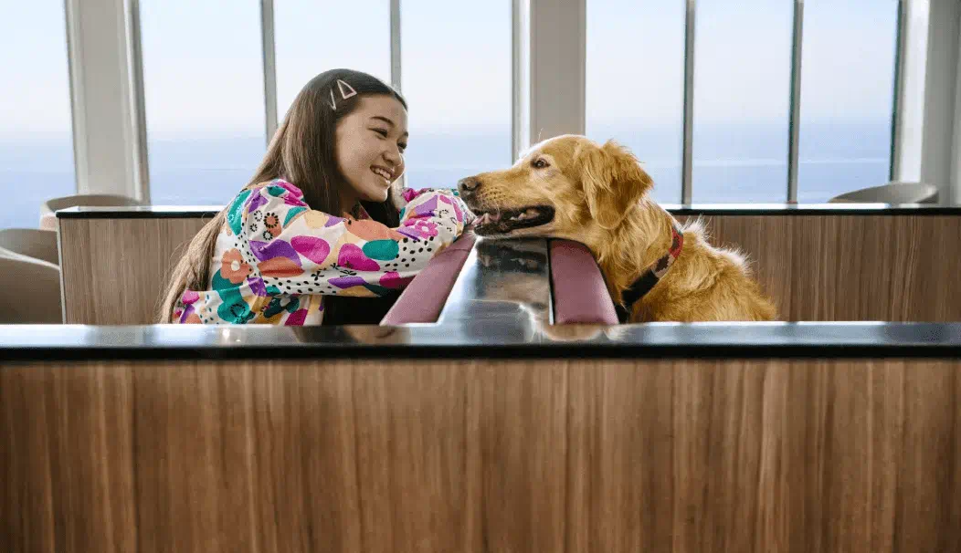girl looking at dog on a ferry