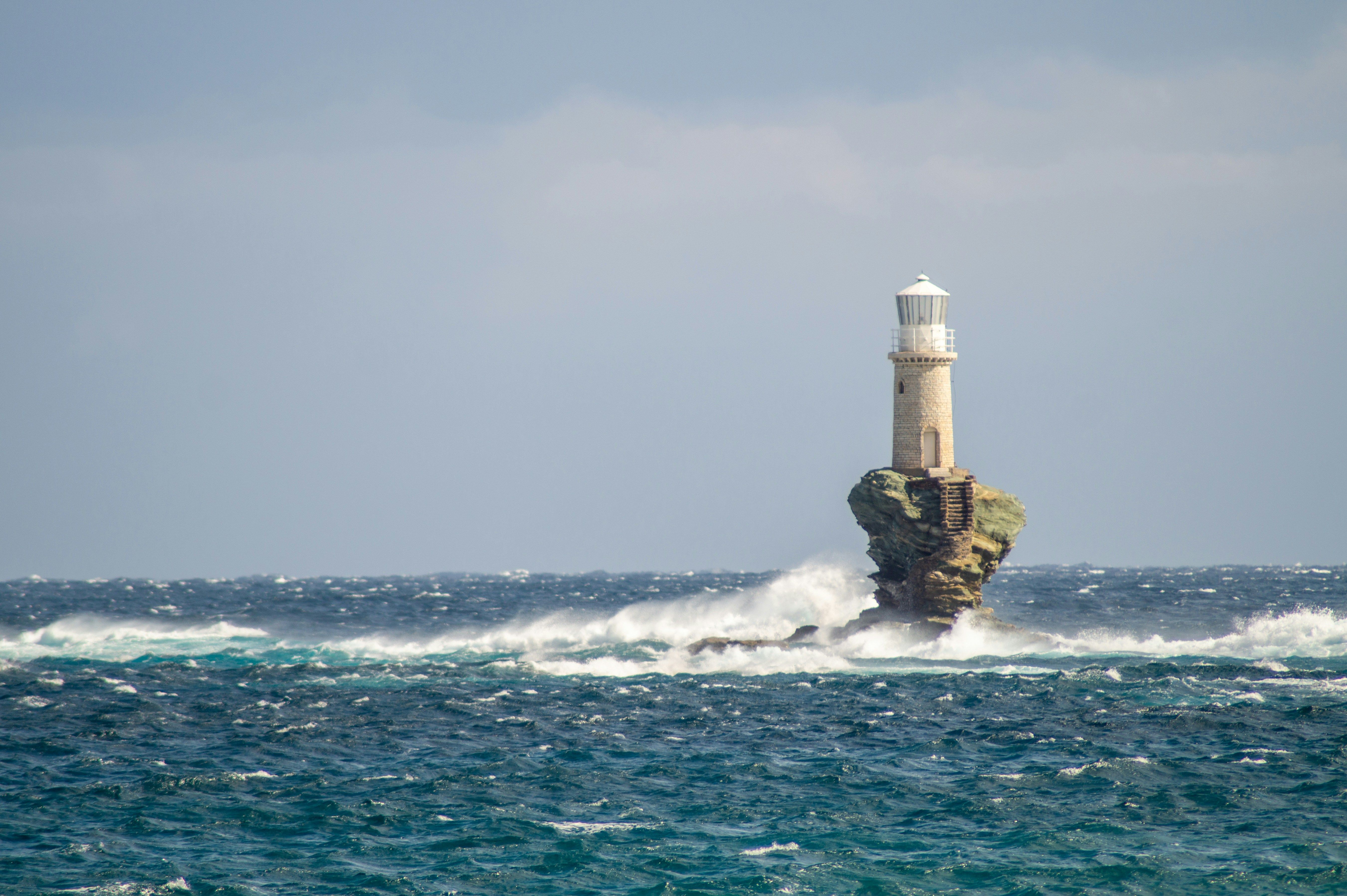 Tourlitis lighthouse on rock in sea