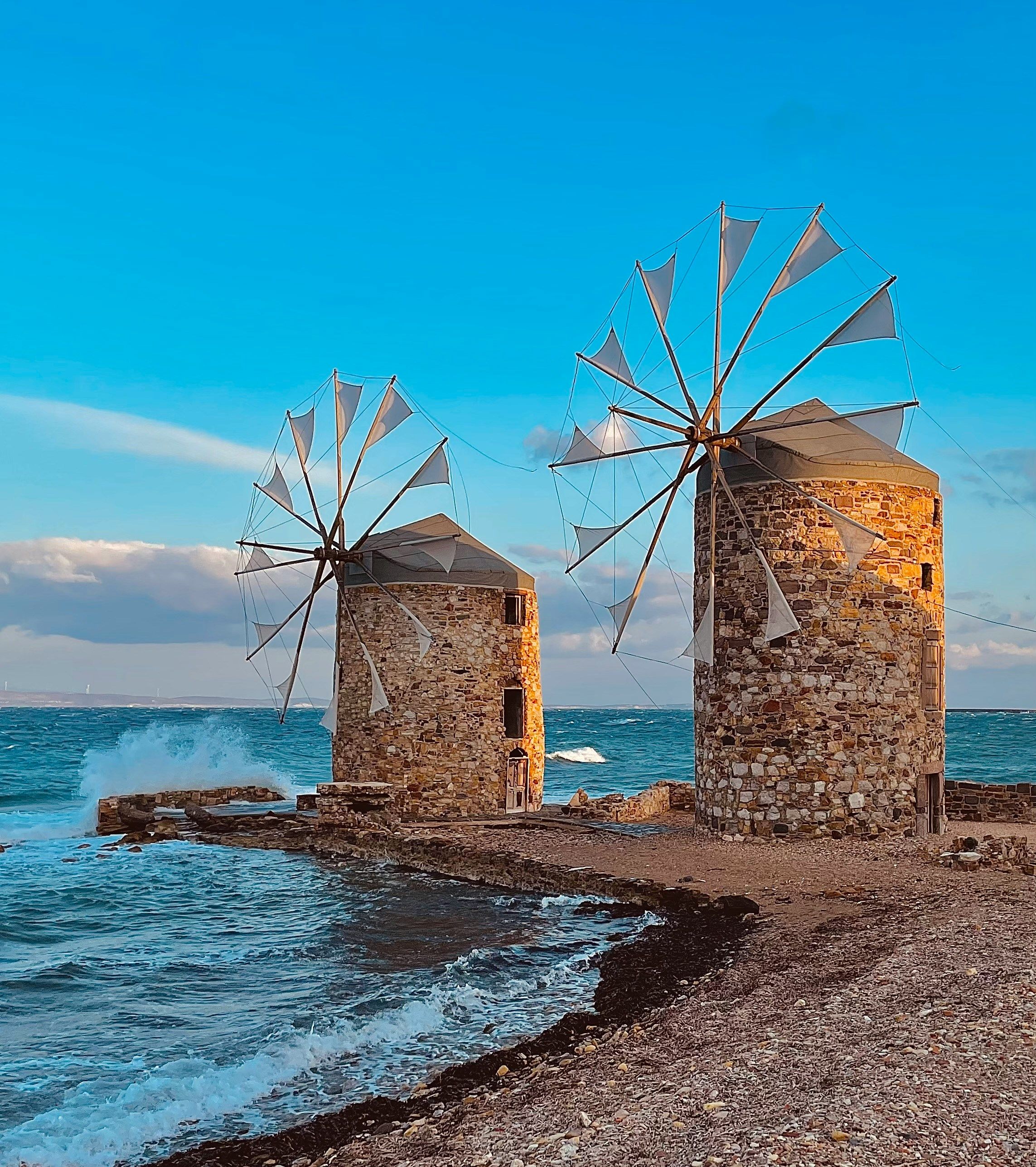 windmills on a rocky bay