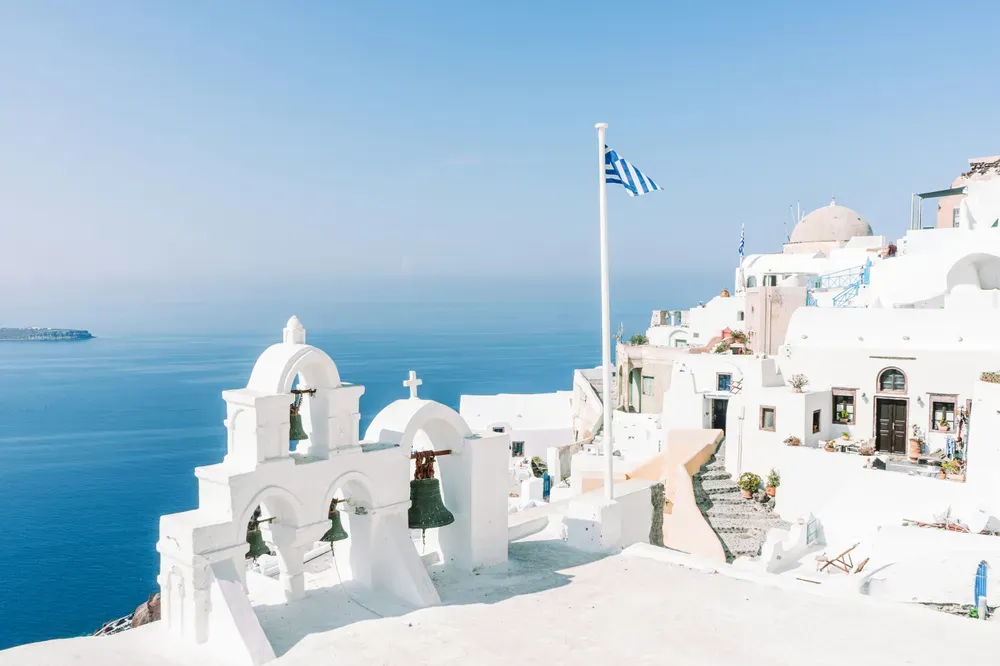 white buildings next to the sea in santorini