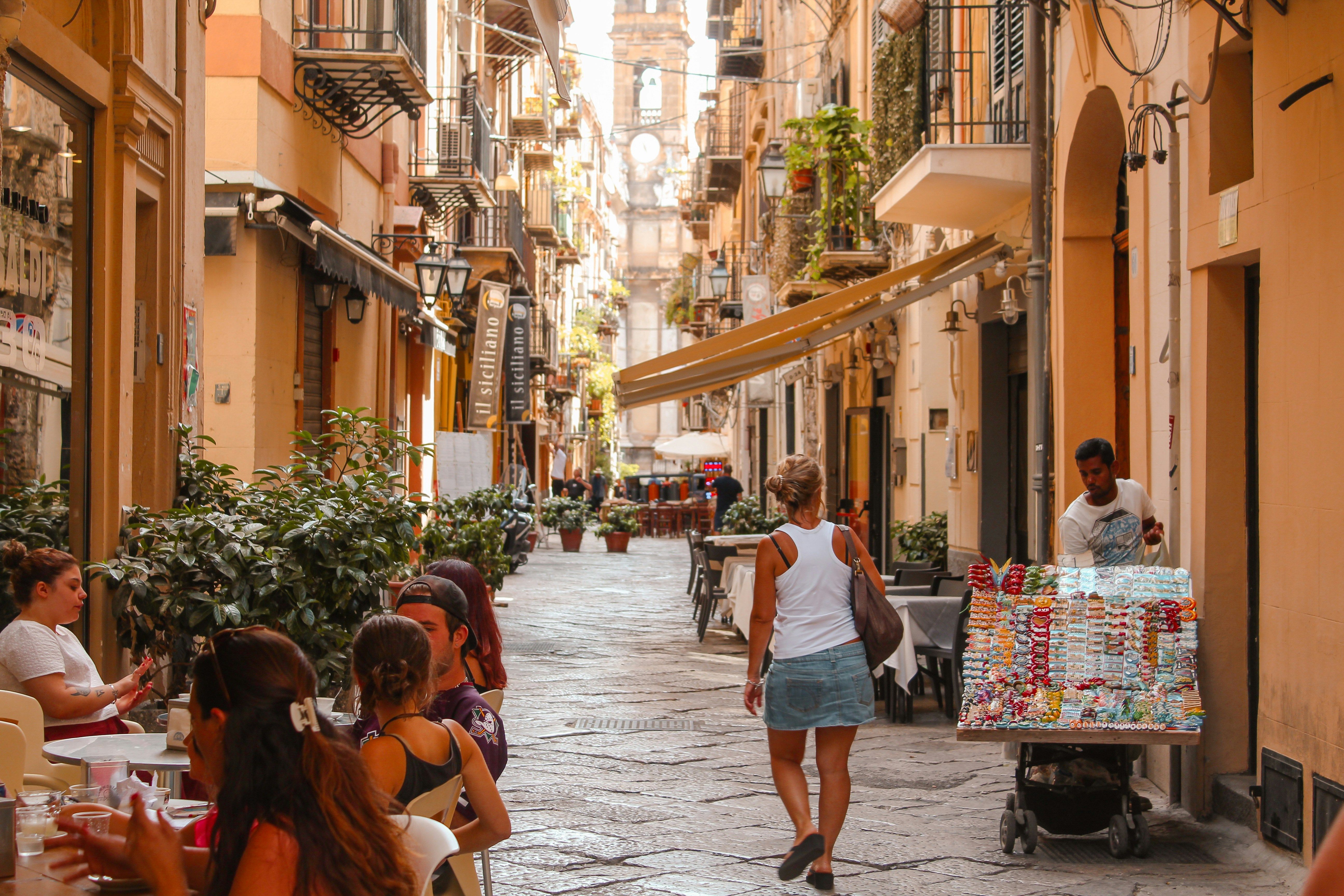 woman walking down narrow street in Palermo