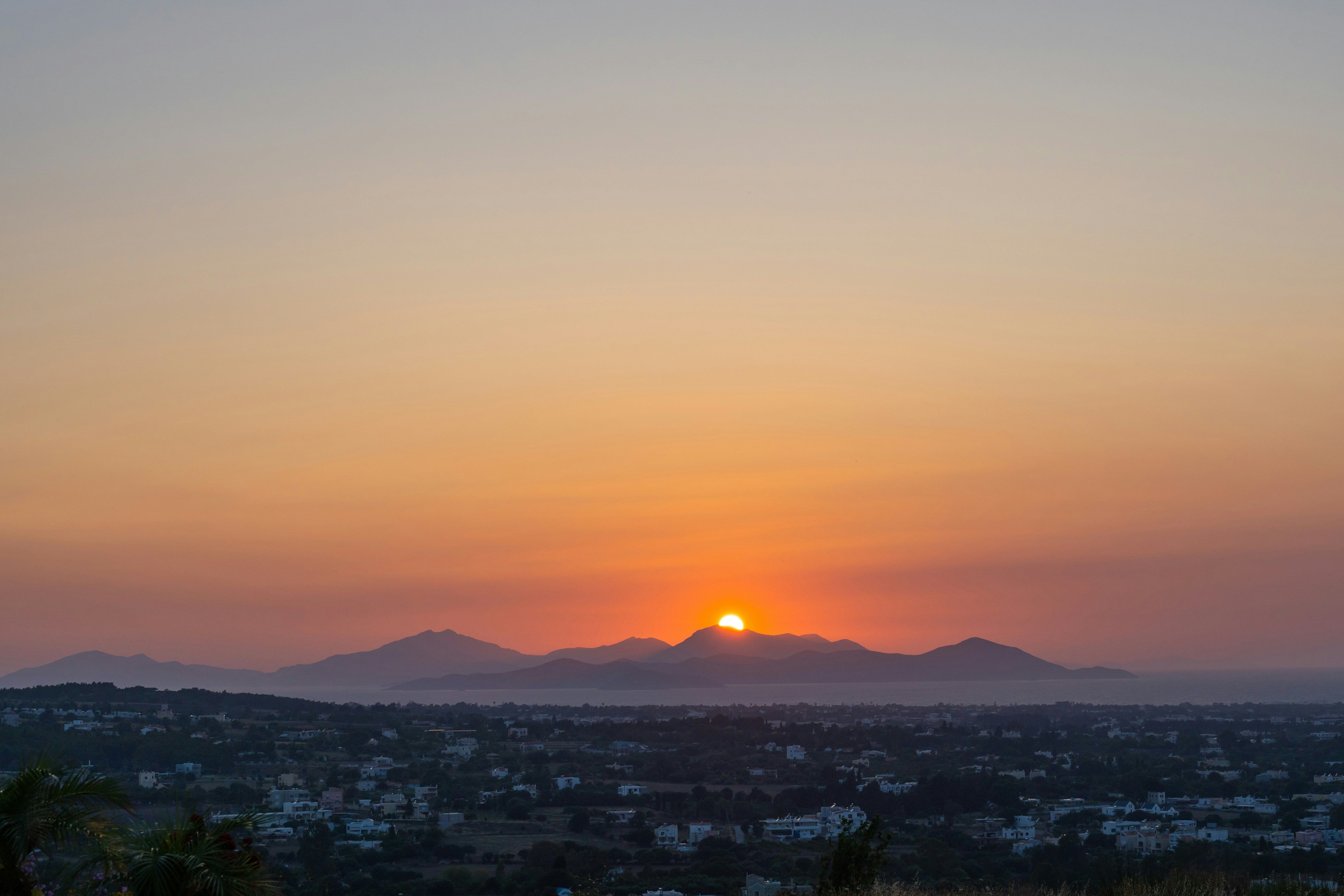 sun dipping behind the mountains in Kos