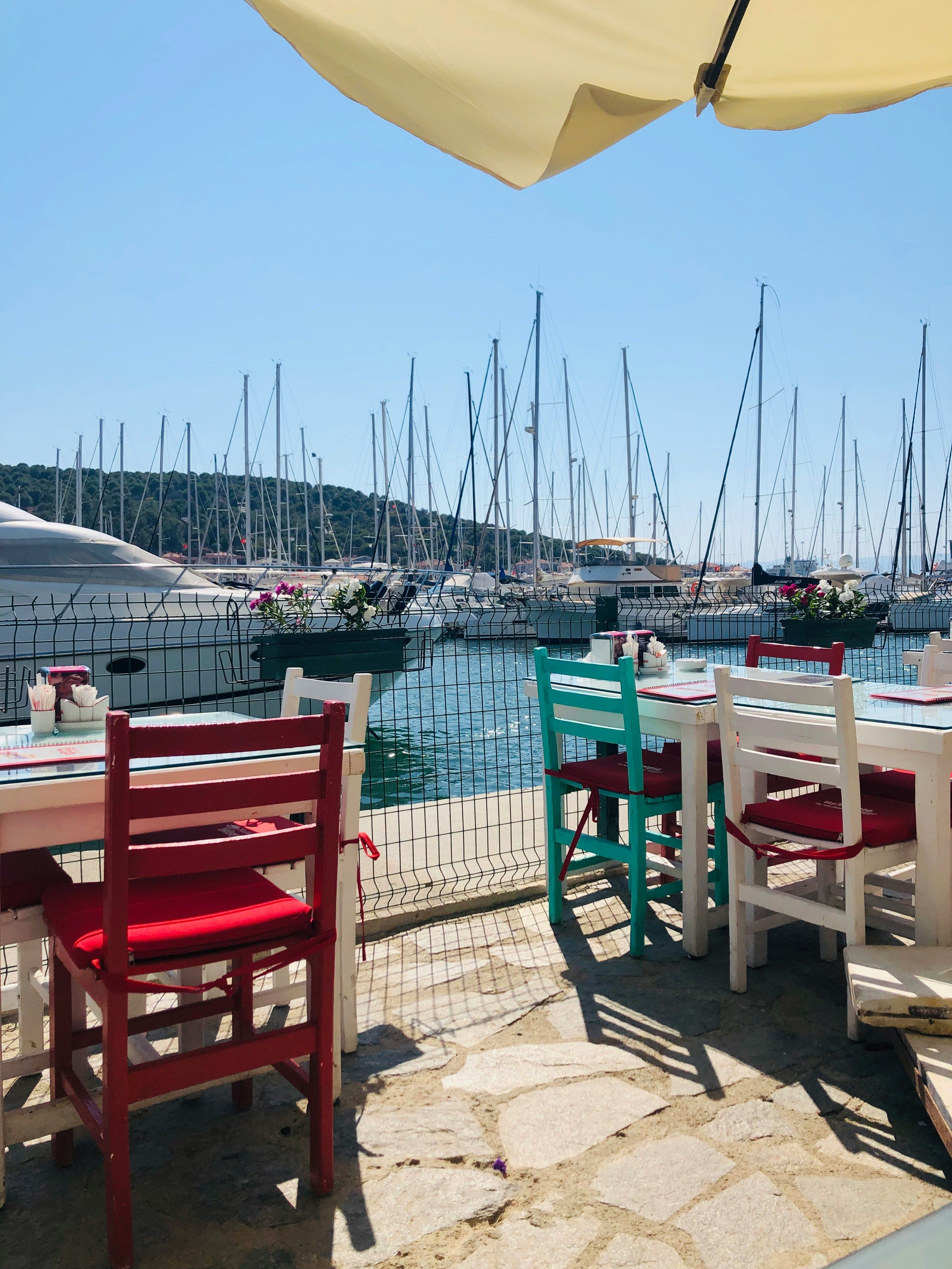 wooden tables overlooking Cesme port